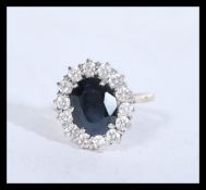 A hallmarked 9ct gold and sapphire and white stone