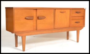 A vintage teak wood sideboard with 2 doors to left, drop down door in middle and 2 drawers to right.