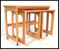 A retro teak wood nest of three Macintosh and Co side tables one long table with two short. The