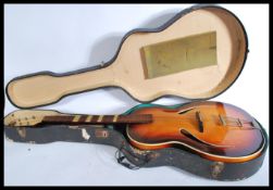 A vintage 20th century The Michigan six string acoustic guitar having a shaped hollow body