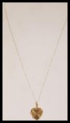 A hallmarked 9ct gold heart pendant on a 9ct gold