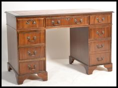 An antique Georgian style mahogany twin pedestal office desk having pedestals, each with banks of
