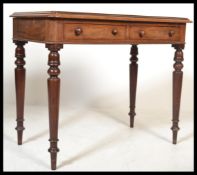 A Victorian mahogany writing table desk being rais
