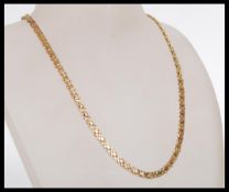 A hallmarked 9ct gold fancy flat link chain necklace having a lobster claw clasp. Import marks for