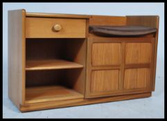 A retro 20th century Nathan teak wood coffee table settle bench cabinet. Qtr panel cupboard door