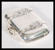 A sterling silver vesta case in the form of a suit