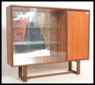 A vintage teak wood display cabinet with glass sli