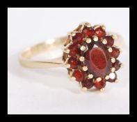 A hallmarked 9ct gold garnet stone cluster ring ha