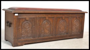 A Jacobean revival oak coffer chest having carved fielded panels to the front, raised on stile