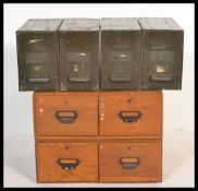 A pair of early 20th century industrial twin wooden filing cabinets along with a set of four metal