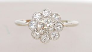 An 18ct white gold diamond cluster ring having a central diamond of approx .30 carats with a halo of