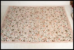 A 20th Century large Indian made 100% cotton bed throw having wool needle work floral motifs running