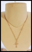 A 14ct gold rolo link necklace chain having a 14ct gold crucifix pendant. Weighs 3.5 grams.