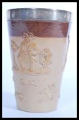 A 19th century Doulton Lambeth salt glazed stoneware beaker cup having a silver hallmarked collar.