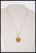 A gold 1/10 oz Krugerrand pendant necklace having a 1/10 1983 South African Krugerrand coin set in a