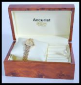 A hallmarked 9ct gold Accurist ladies wrist watch set to a 9ct gold watch bracelet. Complete in