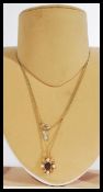 A hallmarked 9ct gold necklace pendant of scrolled