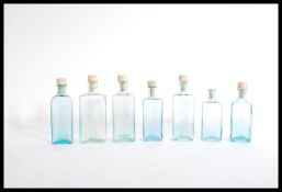 7 vintage blue / green glass medicine, quack cure bottles with notation at the fromt. Please see