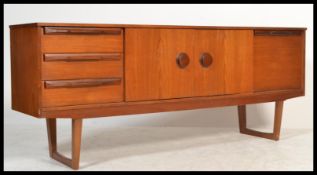 A 1970's retro vintage teak wood long john sideboard comprising of a twin door cupboard with