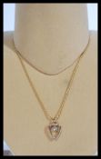 A 14ct gold fine rope twist necklace chain having a yellow metal and white stone heart pendant.