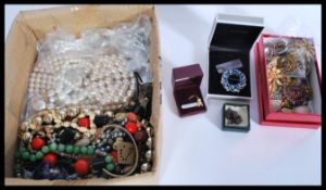A collection of vintage costume jewellery including bangles , beads , brooches along with a 9ct gold