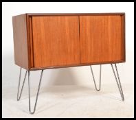 A vintage retro 20th century teak media cabinet sideboard of small proportions having twin sliding