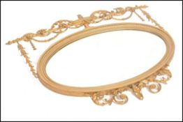 A 19th Century Adams Revival oval mirror with gilt
