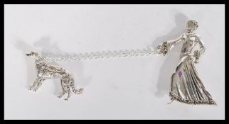 A sterling silver brooch in the form of lady walki