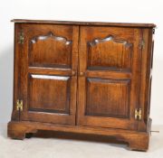 An 18th century revival style oak hostess cabinet.