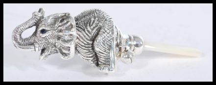 A sterling silver and mother of pearl babies rattl