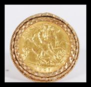 An early 20th century gold half sovereign ring having an inset 1907 Edwardian half sovereign in