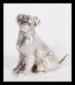 A silver miniature model figurine of a retriever d