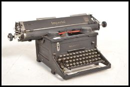 An early 20th century vintage industrial manual typewriter by Imperial, having an A3 roller.