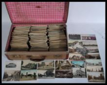 British postcards. Accumulation (2,300 approx) of vintage topographical views in old suitcase.