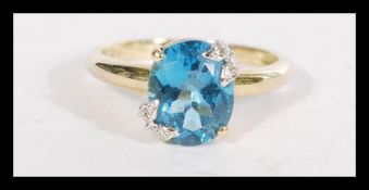 A hallmarked 9ct gold blue stone and diamond accen