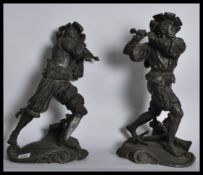 A pair of early 20th century spelter figurines of Spanish soldiers on scrolled bases holding