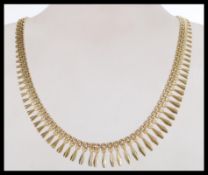 A hallmarked 9ct gold Italian designer Cleopatra choker drop necklace having a clip clasp. Weighs