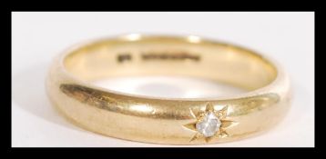 A hallmarked 9ct gold band ring having an inset di