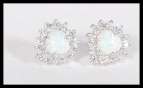 A pair of sterling silver cz and opal earrings hav