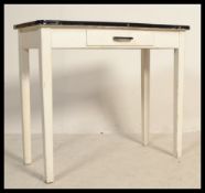 A vintage mid 20th Century enamel topped dining table together three vintage beech stools raised