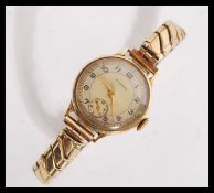 A hallmarked 9ct gold ladies cocktail watch by Yeoman having a champagne dial with silver chapter
