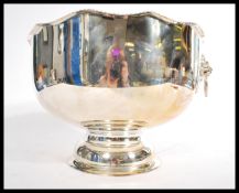 A large unused silver plated lion mast twin handled gadrooned edge pedestal punch bowl, stamped to