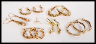 A collection of seven pairs of 9ct gold earrings including hoops , rope twist etc. Weighs 9.8