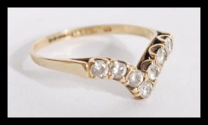 A hallmarked 9ct gold and white stone wishbone rin