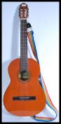 A vintage 20th Century six string acoustic guitar by Raimundo, paper label to centre with rainbow