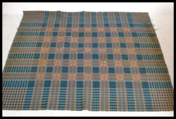 A vintage 20th Century traditional Welsh woollen carthen type fringed blanket with geometric