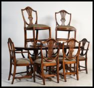 A good quality Regency revival mahogany pedestal extending leaf dining table raised on a reeded