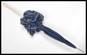 An early 20th century Edwardian ladies silk parasol umbrella having a faux ivory handle of twist