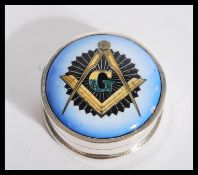 A sterling silver and enamel Masonic interest pill box of circular form. Weighs 16.9 grams.
