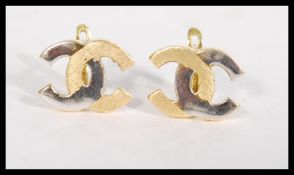 A pair of 18ct gold earrings having an entwined CC